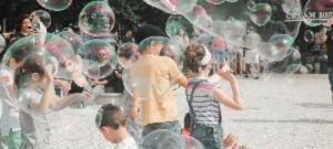 Children Playing In Bubbles